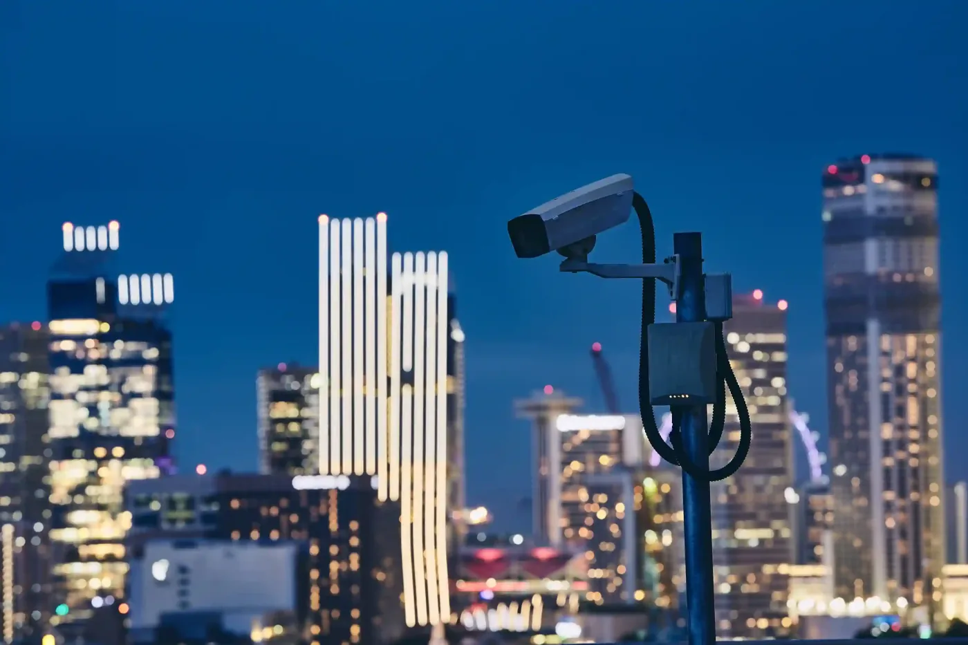 Security camera overlooking a city skyline at night.