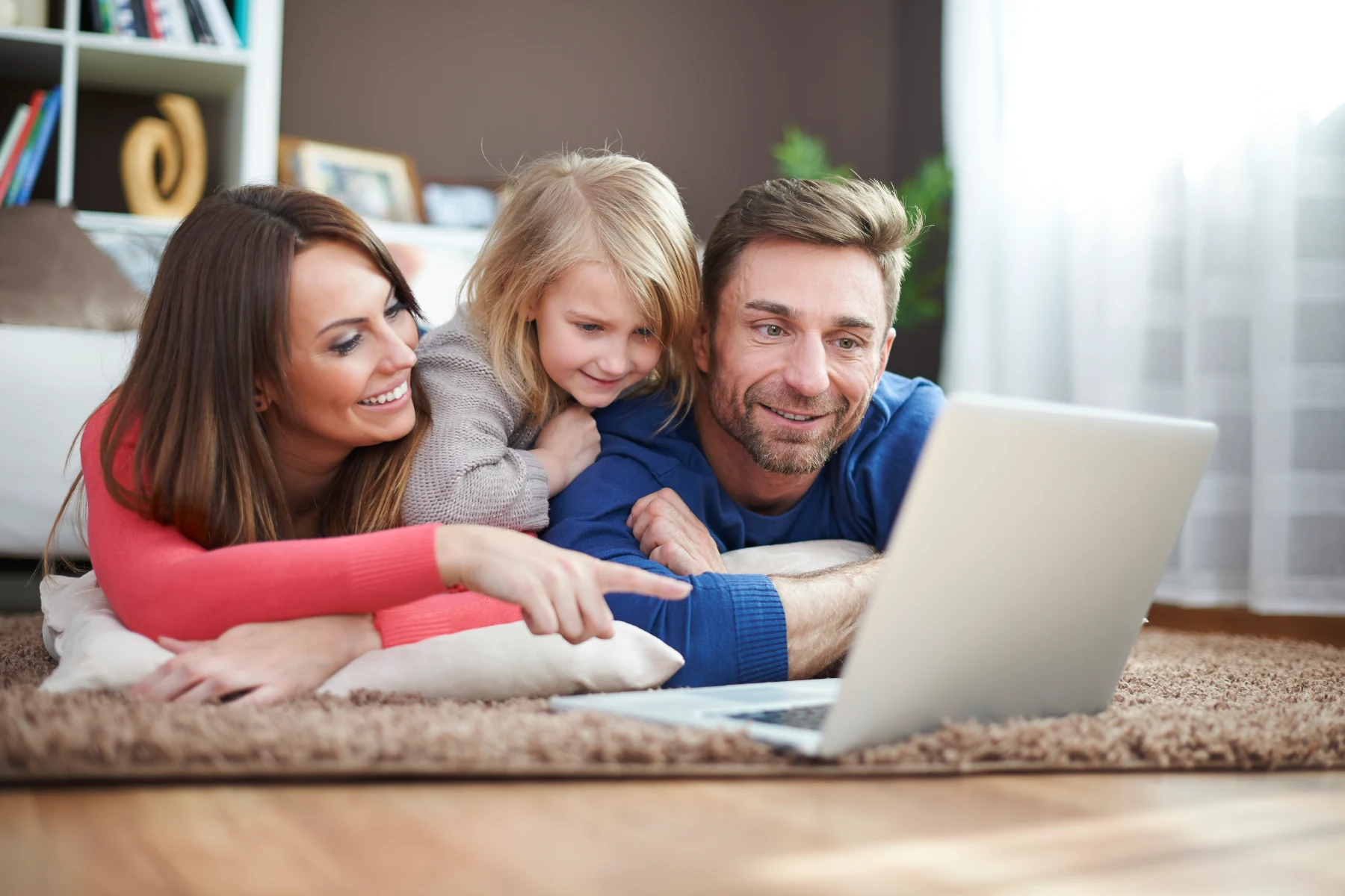Family enjoying time together on a laptop.